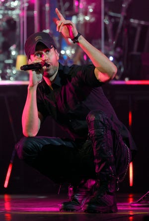 Casually dressed Enrique Iglesias urged fans to go "crazy" after the long wait for the tour to launch.