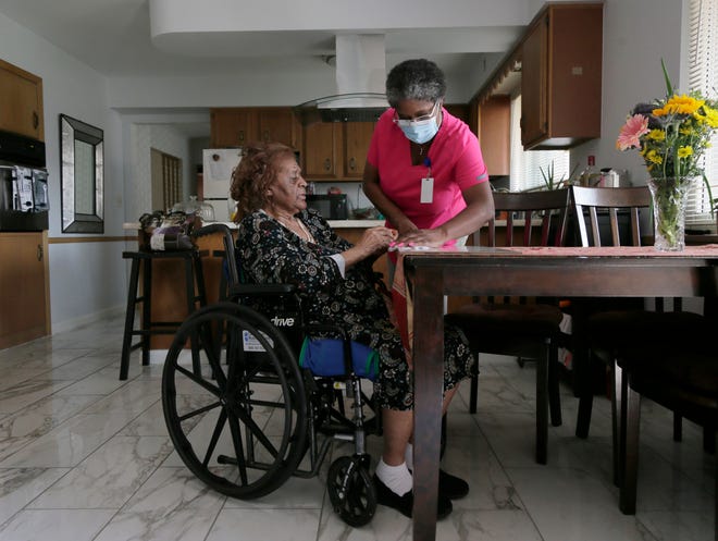 Patricia Carson of Berwick is the guardian for her 84-year-old mother, Lula Slayton who has dementia and uses a wheelchair. Patricia has an aide, Melinda Howell, H.H.A., to help care for her live-in mom during weekdays but struggles to find help for evenings and weekends. Howell cleans up after Lula's lunch on Monday, September 13, 2021.