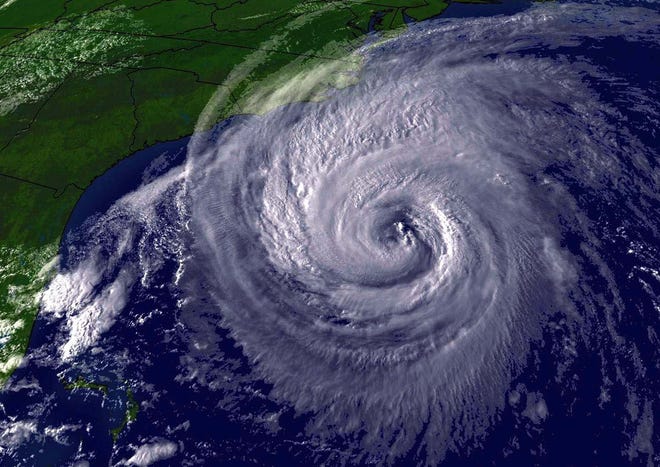 Satellite picture of Hurricane Isabel spinning offshore in September 2003 before it pummeled the Outer Banks. The storm then moved up the East Coast to cause more damage. COURTESY OF NOAA