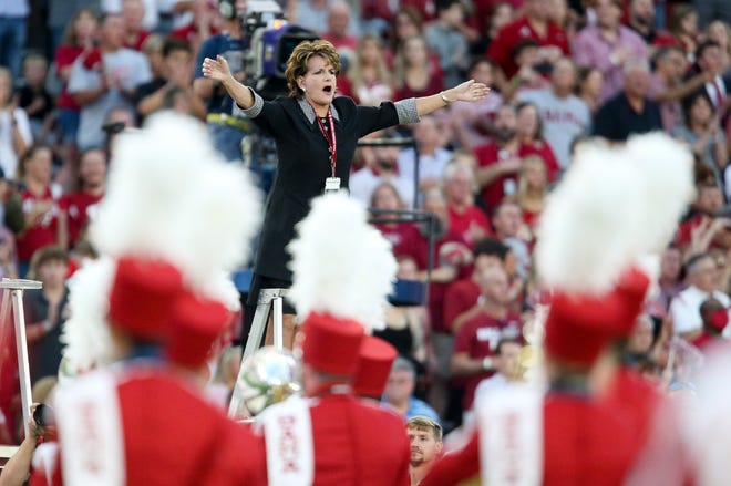 Kathryn Scott, director of the Million Dollar Band from 1984 to 2002, directs the national anthem before Alabama's game with Southern Miss at Bryant-Denny Stadium. Alabama defeated Southern Miss 63-14. [Staff photo/Gary Cosby Jr.]