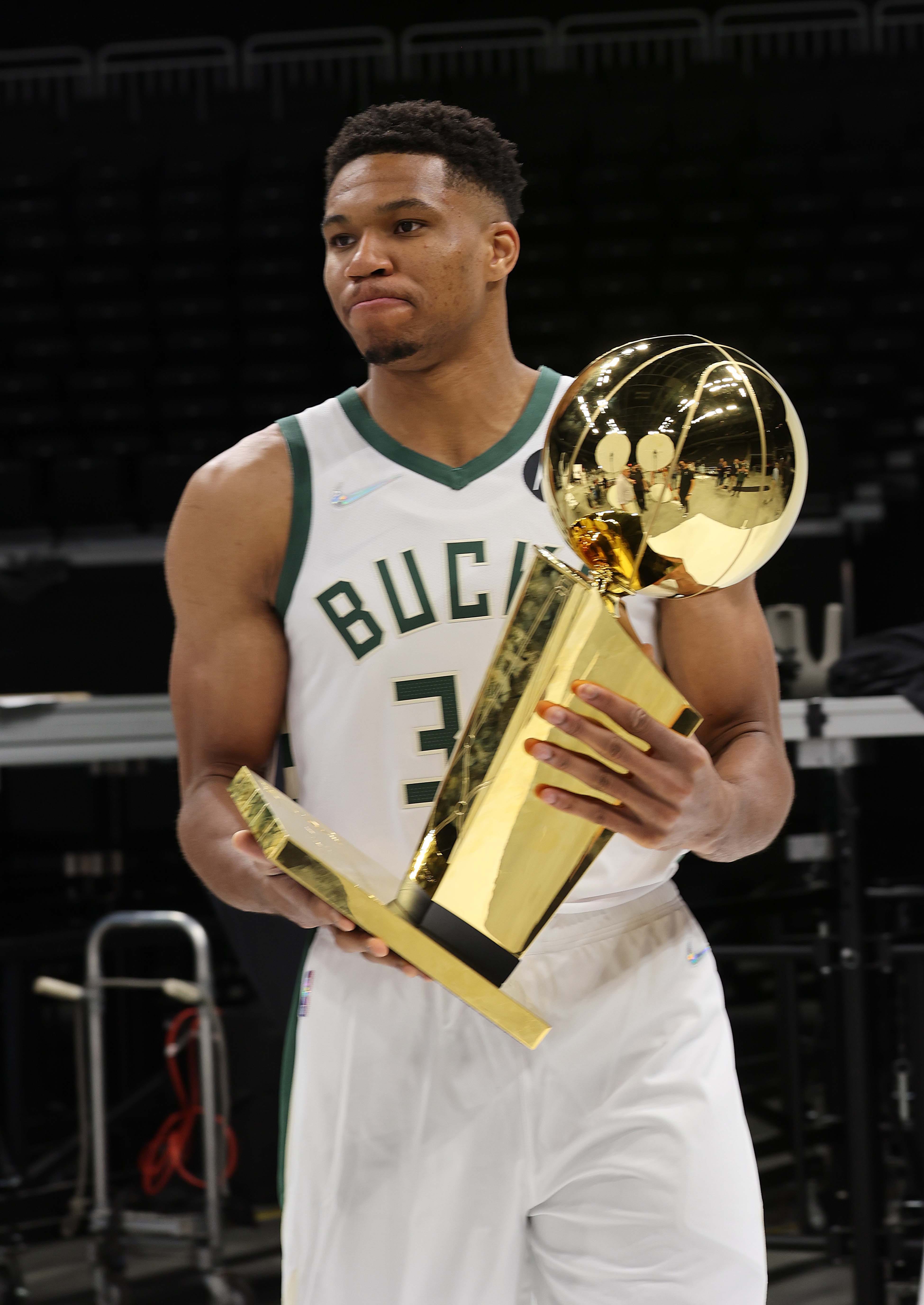 Giannis Antetokounmpo Milwaukee Bucks Unsigned 2021 NBA Finals Larry O'Brien Trophy and Bill Russell MVP Photograph