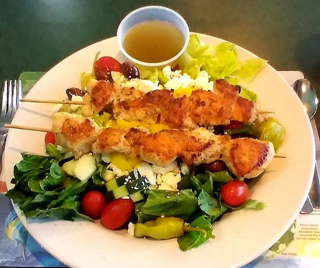 The Greek salad was a bounty of fresh colorful ingredients with two skewers of chicken added at an additional charge.