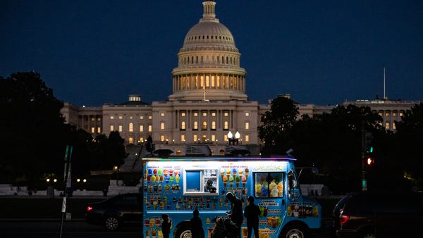 A family buys ice cream at a food truck on the Nat