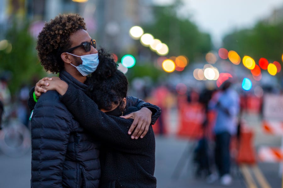 A couple embrace at Black Lives Matter Plaza near the White House on April 20.