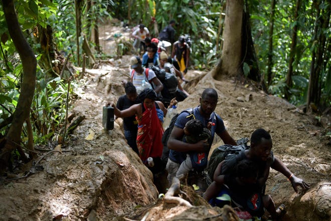 Haitian migrants cross the darien gap jungle near ecandi, choco department, colombia, towards panama in their attempt to reach the united states on september 26, 2021.