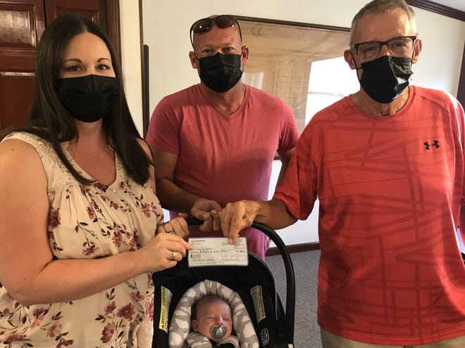 Melissa Halsall, left chairman of Galva Freedom Fest and her husband Carson, middle also a member of the committee presented Mayor Rich Volkert a check for $20,000 that the committee raised for  the July 4th activities at Monday night city council meeting.  Also pictured is Halsall’s son Walter. 
Mayor Volkert thanked the committee and said, “This is terrific work and very outstanding.”