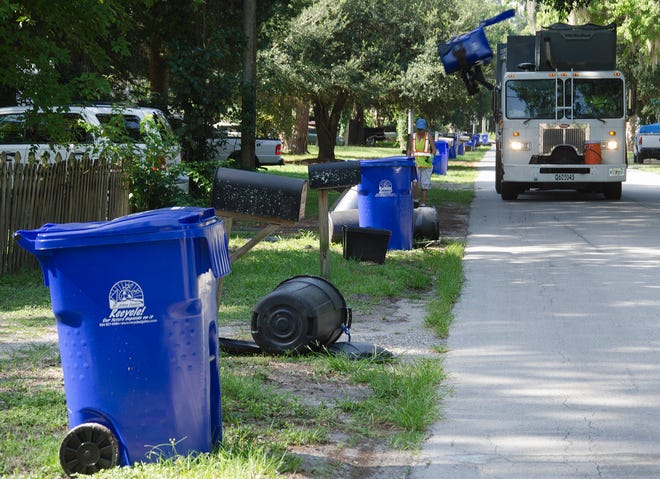 A recycling truck lifts a 95-gallon recycling container from the front of a home in  St Augustine in 2015.