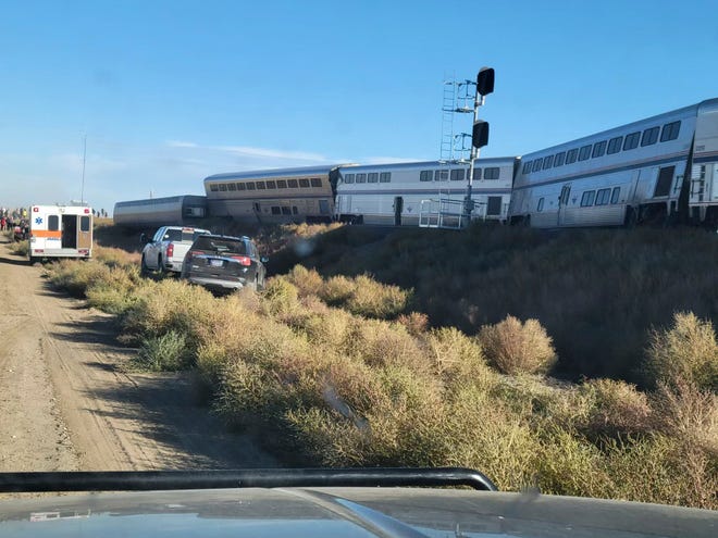 In this photo provided by Kimberly Fossen an ambulance is parked at the scene of an Amtrak train derailment on Saturday, Sept. 25, 2021, in north-central Montana. Multiple people were injured when the train that runs between Seattle and Chicago derailed Saturday, the train agency said.