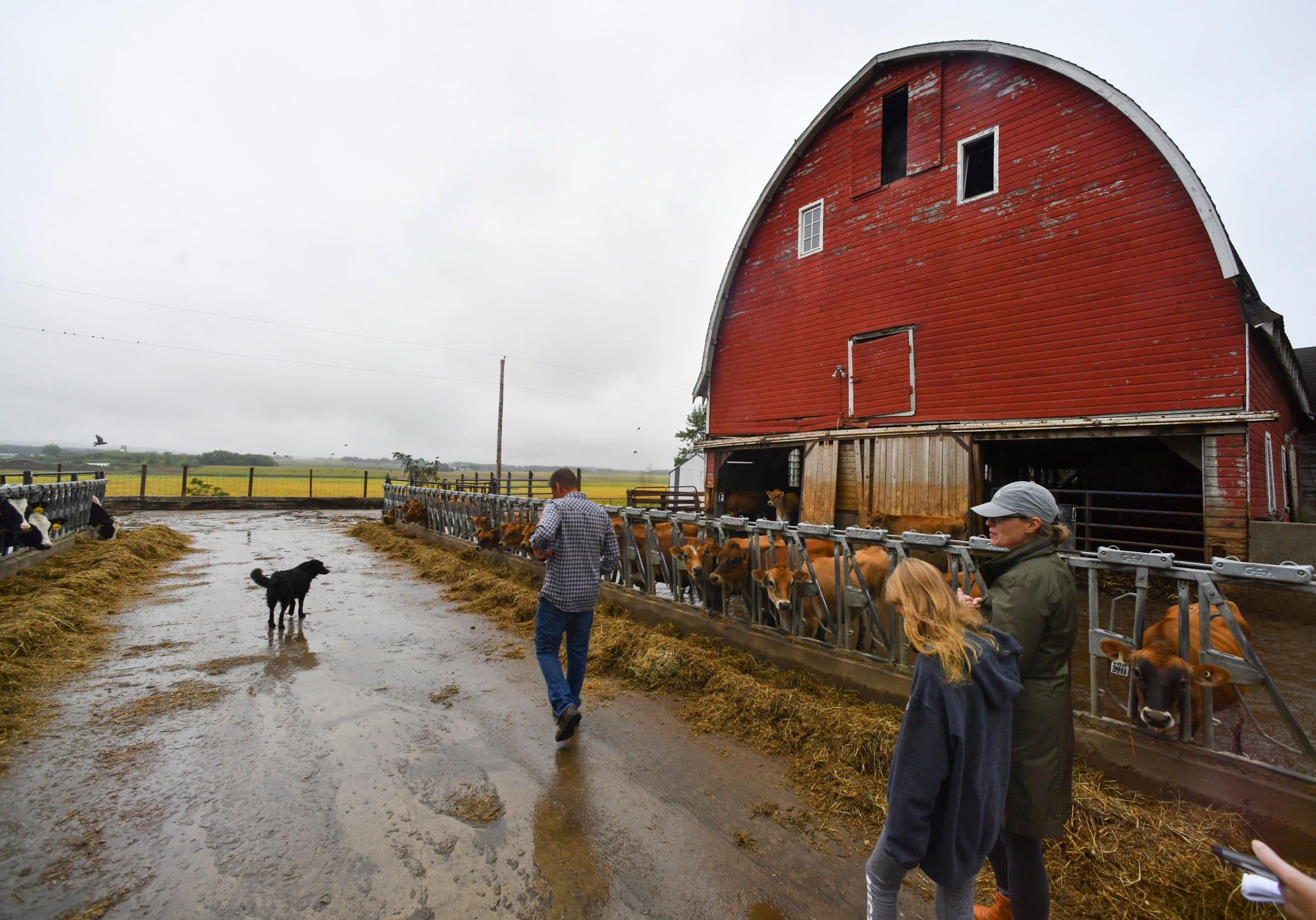 Lahr family members walk past a barn on their farm Sept. 3 near Cold Spring.