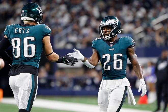 Philadelphia Eagles' Zach Ertz (86) and Miles Sanders (26) celebrate after Ertz caught a touchdown pass in the second half of an NFL football game against the Dallas Cowboys in Arlington, Texas, Monday, Sept. 27, 2021. (AP Photo/Michael Ainsworth)