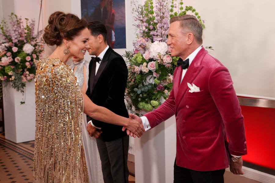 Duchess Kate meets Bond, James Bond, otherwise known as actor Daniel Craig in his last turn as Agent 007. He wore a magenta velvet jacket for the long-delayed premiere, which drew a star-studded array of celebrities and other royals on the red carpet.