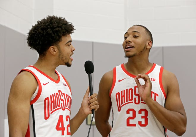 Zed Key (23) is interviewed by teammate Harrison Hookfin during media day.