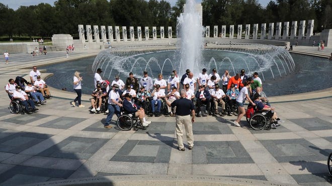 Veterans get ready for a group photo as they visit the World War II Memorial in Washington, D.C., during the Sept. 11 Space Coast Honor Flight.