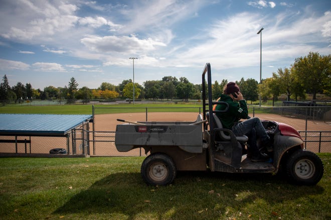 City employees maintain the softball fields at Rolland Moore Park in Fort Collins in September.