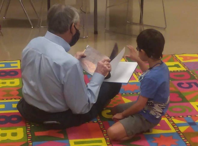 Paul Clayton helps a young member of First United Methodist Church's congregation with reading while FUMC hosted students for virtual learning during the COVID-19 pandemic in 2020.