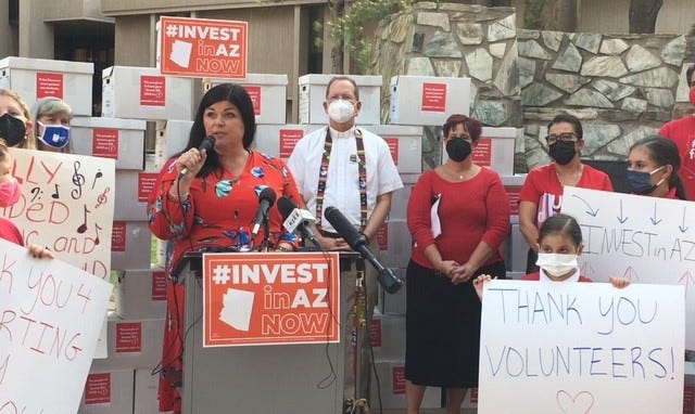 Beth Lewis, director of Save Our Schools, speaks at a rally on Tuesday, Sept. 28, 2021, before delivering thousands of citizen petitions to put Arizona’s flat tax on hold until voters can decide in November 2022.