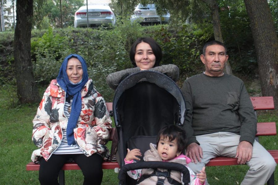 Fatema Hosseini, center, with her mother, Masuma, father, Sayed Amin and little sister Mobina in a park in Kyiv after they were reunited safely in Ukraine.