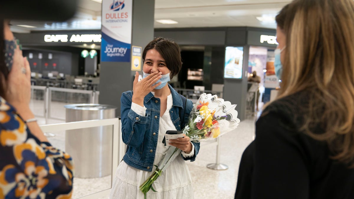 Afghan journalist Fatema Hosseini is greeted by USA TODAY Editor in Chief Nicole Carroll and publisher Maribel Wadsworth at Dulles International Airport after being evacuated from Kabul.