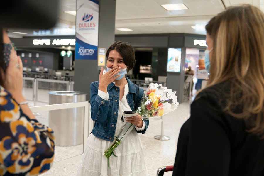 Afghan journalist Fatema Hosseini is greeted by USA TODAY Editor in Chief Nicole Carroll and publisher Maribel Wadsworth at Dulles International Airport after being evacuated from Kabul.