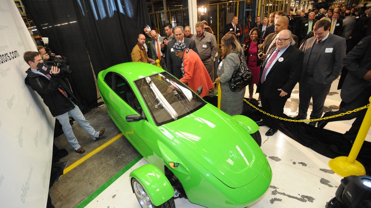 Elio Motors shows off an early version of its prototype 3-wheeled, 84 mpg, two-seat vehicle at a press conference in 2013 to promote its deal to take over the former General Motors property in Shreveport, Lousiana, where the company promised to add 1,500 jobs.