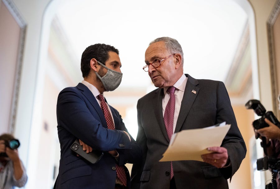 Senate Majority Leader Chuck Schumer, D-N.Y., talks to an aide following a Democratic policy luncheon at the U.S. Capitol on Sept. 28, 2021 in Washington, D.C.