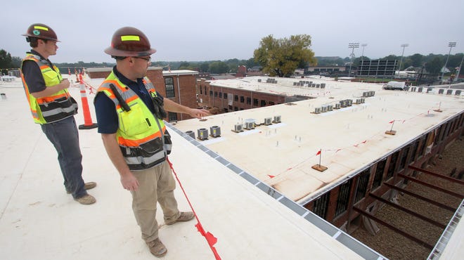 Project engineer Adam Kirby and project manager Jake Somsel look out from the roof of the old Trenton Mills on West Main Avenue Thursday morning, Sept. 30, 2021.