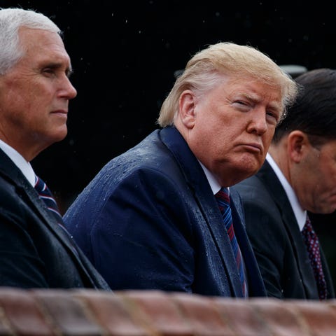President Donald Trump, center, flanked by Vice Pr