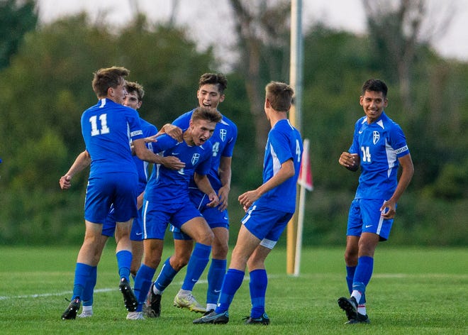 Marian players celebrate with Jaxson Hundt after he scored during the Marian vs. Saint Joseph soccer match Wednesday, Sept. 29, 2021 at Marian High School. 