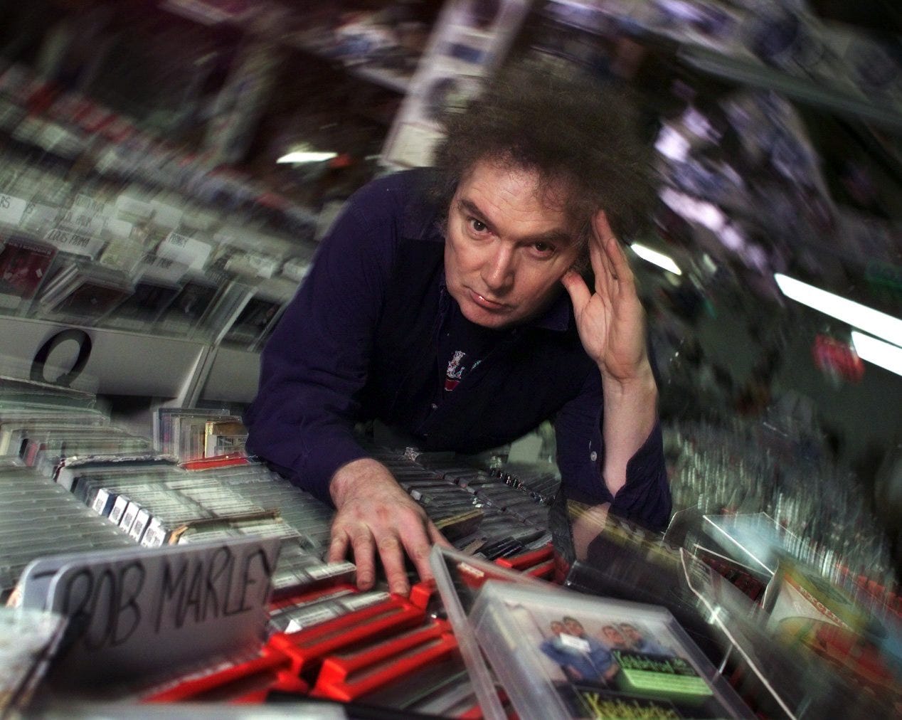 From 1998: Armond Schaubroeck, co-owner of House of Guitars, in his overflowing store.