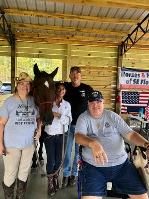 (From left) Denise Brown, Karen Woodbury, Mark Woodbury and Tom Brown enjoy some equine companionship as part of the Horses & Heroes program.