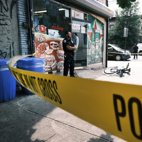Police converge on the scene of a shooting in Broo