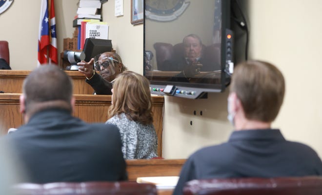 Leon Davis points to Joseph McCabe (right), his neighbor in New Lexington, Perry County, during a trial Sept. 27 in the Perry County Courthouse as one of the men who assaulted him on July 5, 2020 during what he called a racist attack. Following the two-day trial, McCabe was found guilty of an assault charge but not guilty of aggravated menacing and ethnic intimidation. On Monday, Visiting Scioto County Judge Jerry Catanzaro, reflected in the TV, sentenced McCabe to 10 days in jail and racial sensitivity training, among other things.