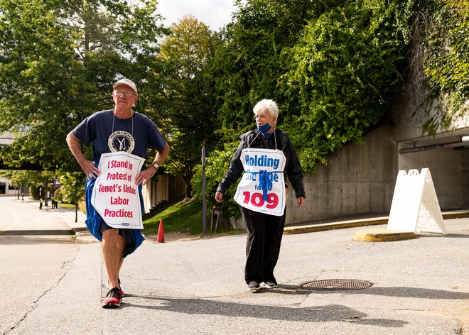 Bill Lahey and Maureen Campanale walk the St. Vincent Hospital nurses picket line Friday in Worcester.