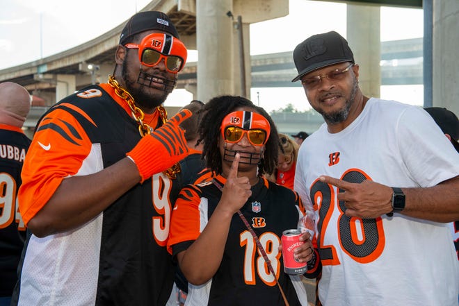 Cincinnati Bengal fans gather in the squares near Paul Brown Stadium and the Bud Light Tailgate Zone before the start of the match.  Pictured: Aaron and Aeja McClure and John Harshaw.
