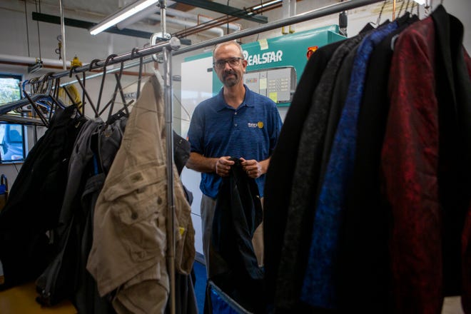 Brad Roach, owner of Fashion and Vanity Cleaners, stands by racks of clothing being pressed and cry cleaned inside of Fashion and Vanity Cleaners in Lancaster, Ohio in September 29, 2021.