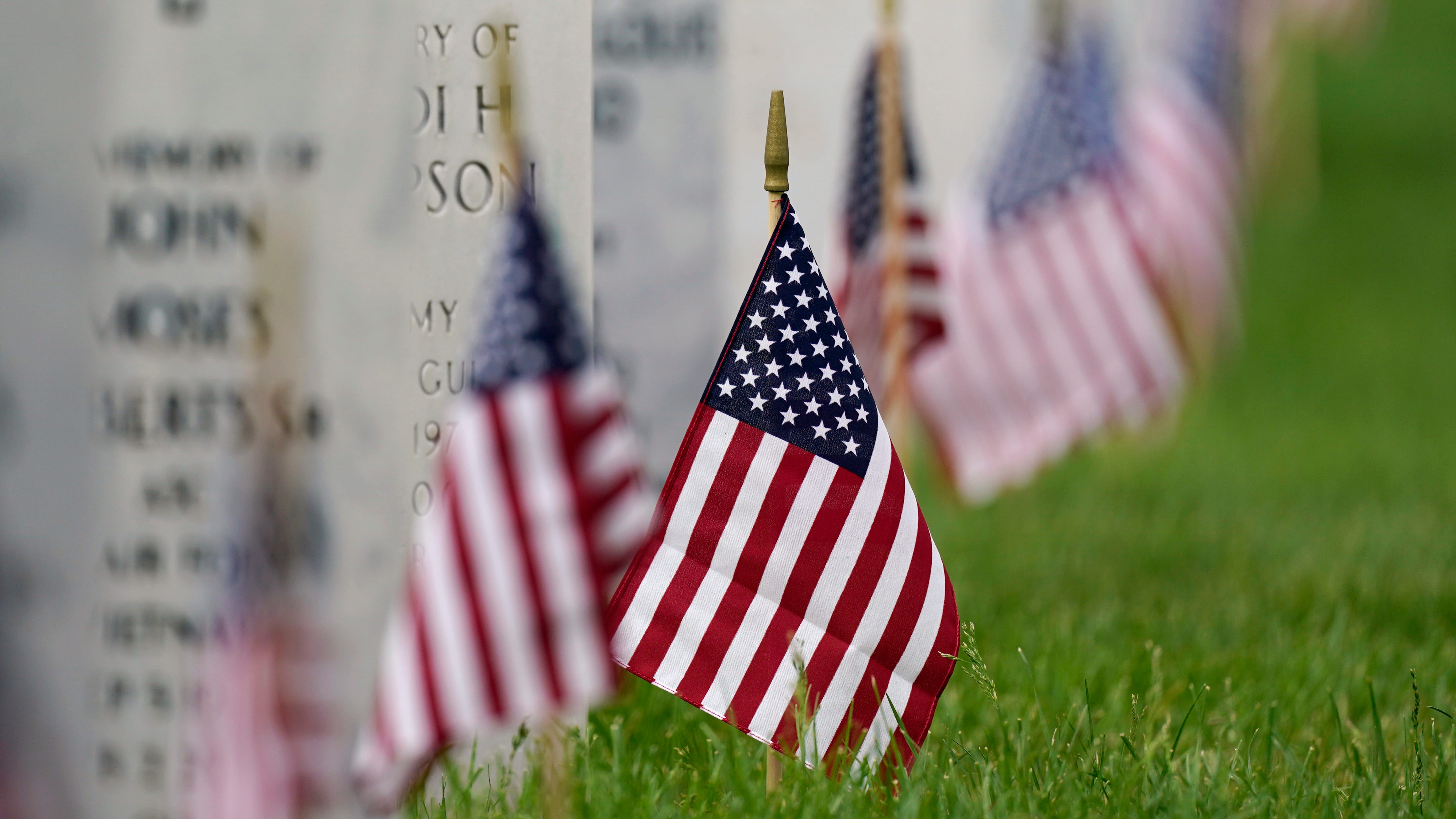 Flags mark gravestones at Fort Logan National Cemetery in Denver on May 31, 2021. The number of U.S. military suicides jumped by 15% last year, fueled by significant increases in the Army and Marine Corps that senior leaders called troubling.