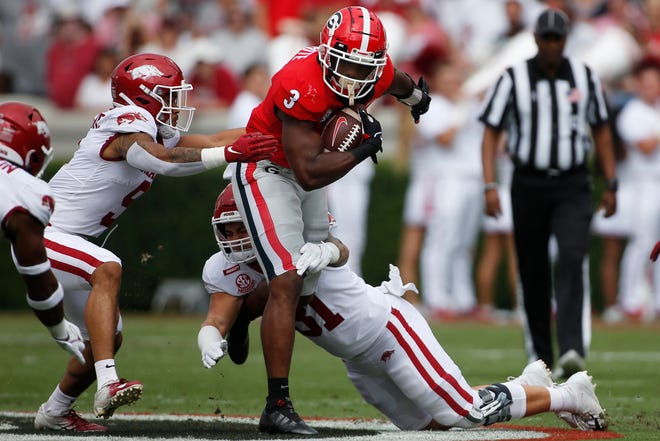 Georgia running back Zamir White (3) moves the ball down the field in the first half of an NCAA college football game between Arkansas and Georgia in Athens, Ga., on Saturday, Oct. 2, 2021.