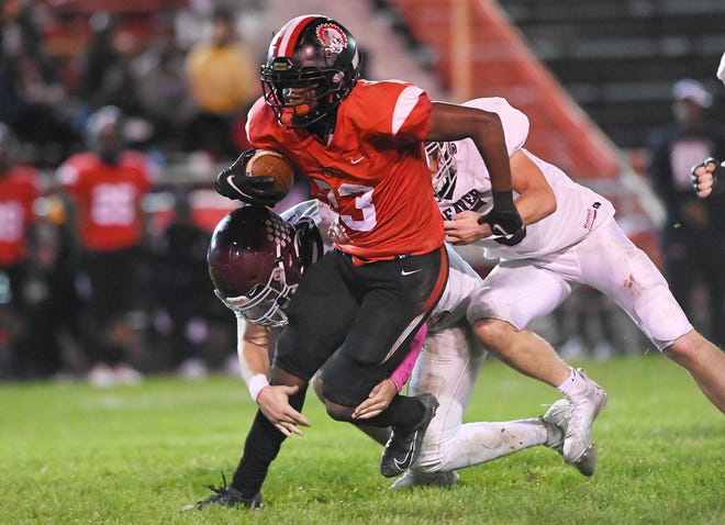 Aliquippa's Tiqwai Hayes carries the ball during Friday night's game against Beaver at Aliquippa.