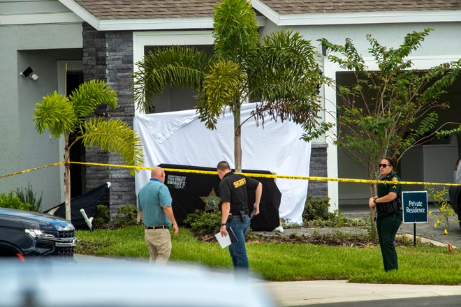 Polk County Sheriff investigators search the scene of a fatal attack in Davenport, Fla., on Saturday, Oct. 2, 2021. ERNST PETERS/ THE LEDGER