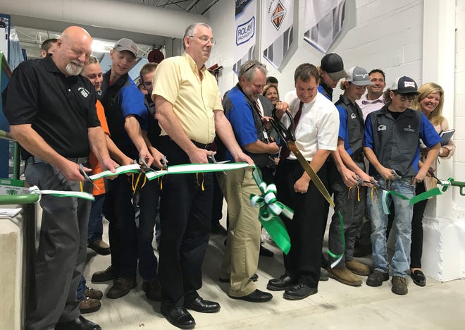 School officials, sponsors and students cut the ribbon to dedicate the new Ahnapee Diesel Center in Casco, which gives high school students the chance to earn a diesel maintenance technician certificate as well as college credits toward becoming a diesel mechanic.