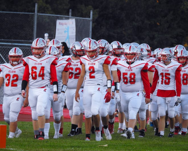Elgin 's football team comes onto the field at Ridgedale last year in a Northwest Central Conference football game.