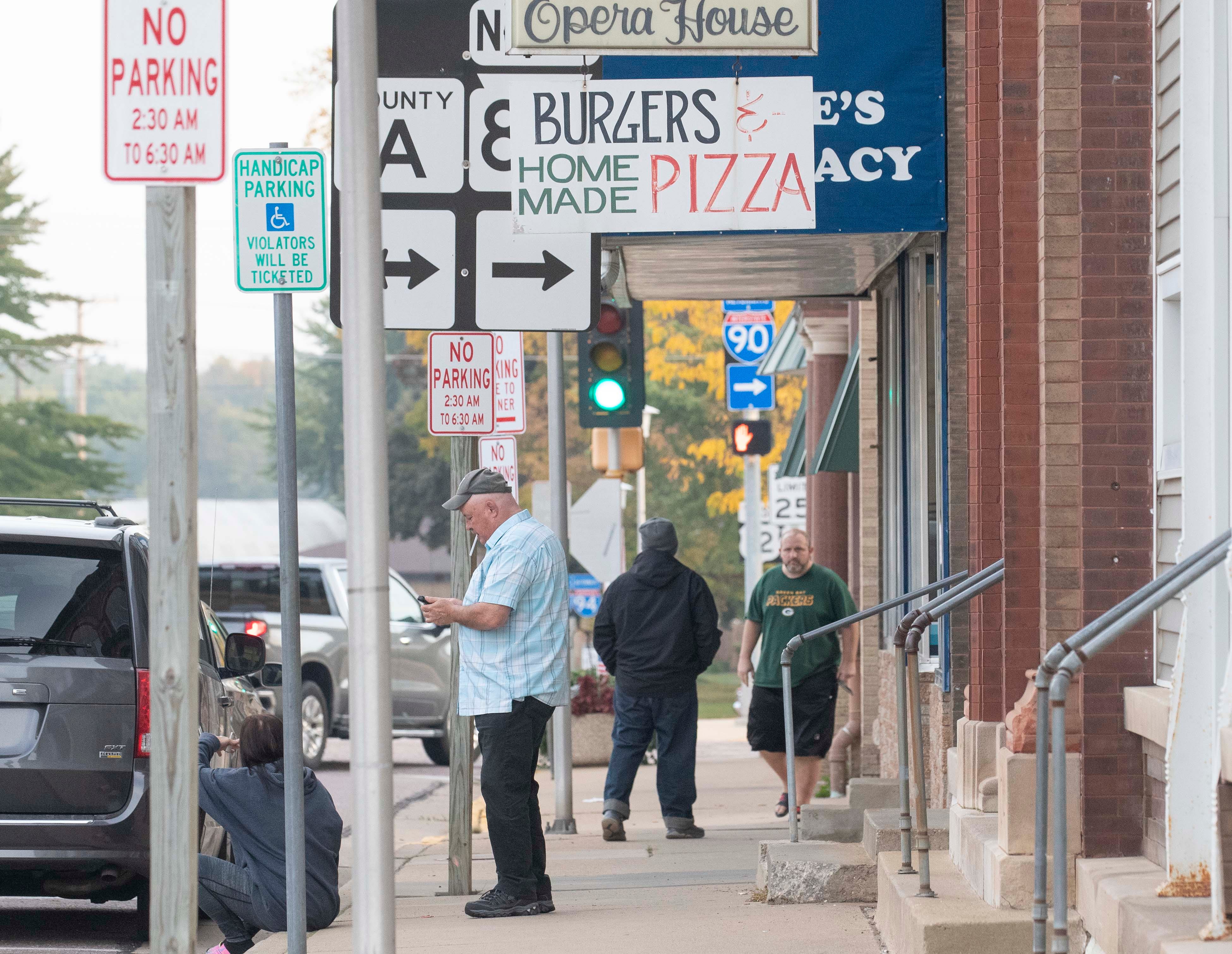 People are seen on South Adams Street in downtown New Lisbon.