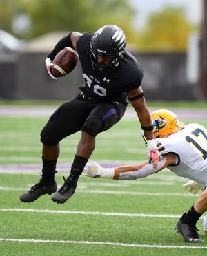University of Sioux Falls' Ja'Tai Jenkins jumps away from a tackle by Augustana's Eli Weber on Saturday, October 2, 2021, at Bob Young Field.