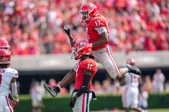 Georgia defensive back Derion Kendrick and linebacker Nakobe Dean react after a play against the Arkansas Razorbacks during the first half at Sanford Stadium.