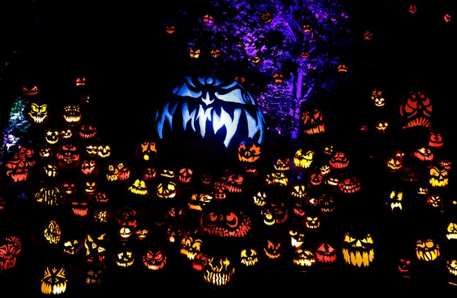A large display of jack-o-lanterns casts a spooky glow at Roger Williams Park Zoo's Jack-O-Lantern Spectacular in this file photo.