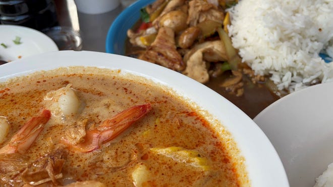 Menu items at Fai Thai include the Masaman Curry and the basil stir fry.