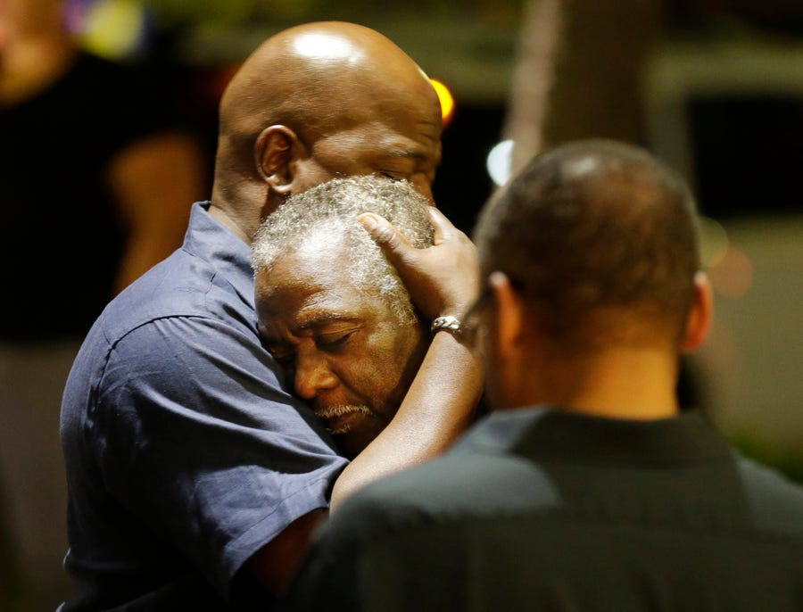 Worshippers embrace following a group prayer across the street from the scene of a shooting at Emanuel African Methodist Episcopal Church, Wednesday, June 17, 2015, in Charleston, S.C. A white man opened fire during a prayer meeting inside the historic Black church, killing multiple people, including the pastor, in an assault that authorities described as a hate crime.
