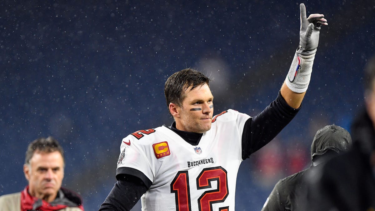 Tom Brady celebrates as he runs off of the field after the Tampa Bay Buccaneers beat the New England Patriots at Gillette Stadium.