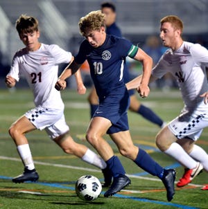 Dallastown's Zander Leik, center, moves the ball with Central York's  Brandon Maida, left, and Kyle Delp in pursuit during soccer at Dallastown Monday, Oct. 4, 2021. Bill Kalina photo
