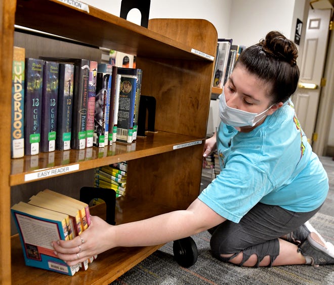 York College volunteer Sophia DeBolt stores books from the Martin Library Children's Library in the basement of the York City library Monday, Oct. 4, 2021. Over 40,000 items are being removed from the children's library before renovations take place there. The upgrades are part of a $10 million libraries expansion project taking place at three county libraries. The project will focus on renovations and upgraded technology for teenagers. DeBolt is with Changemakers, a student community-enhancement group. Bill Kalina photo
